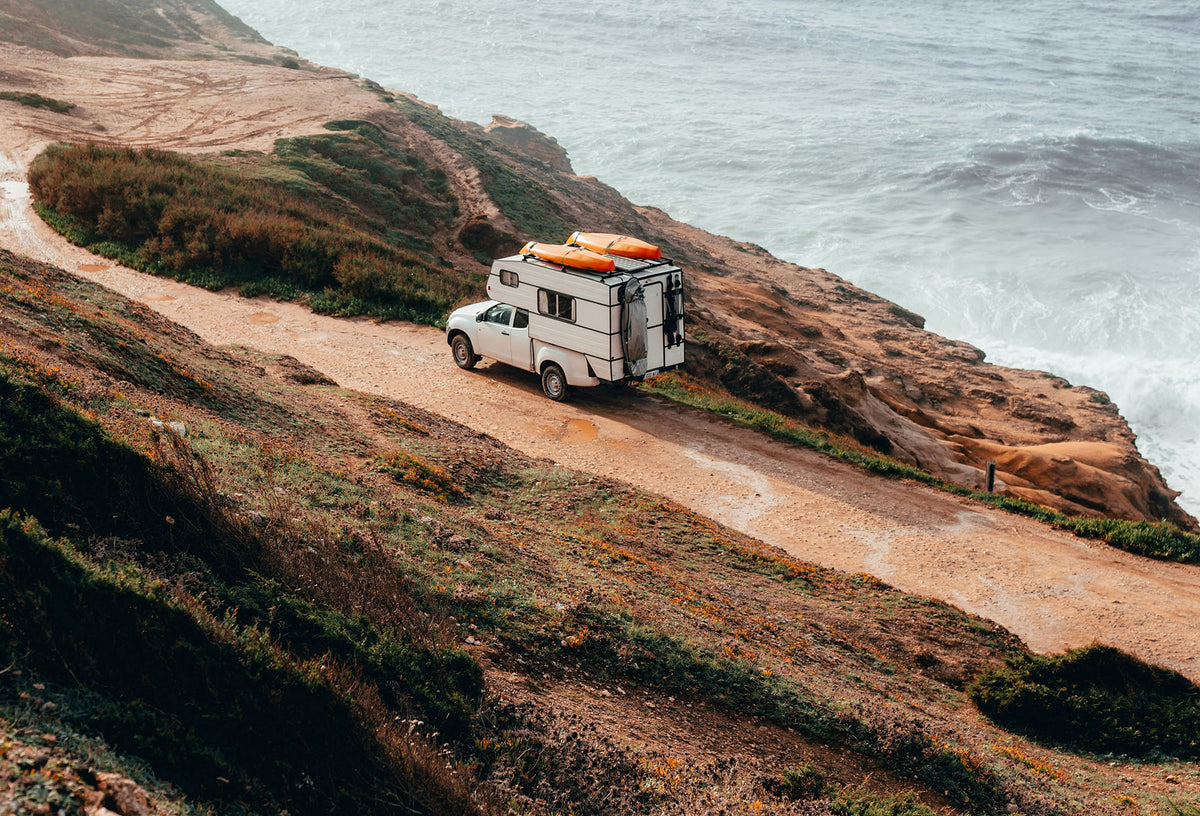 Camper driving along the beach